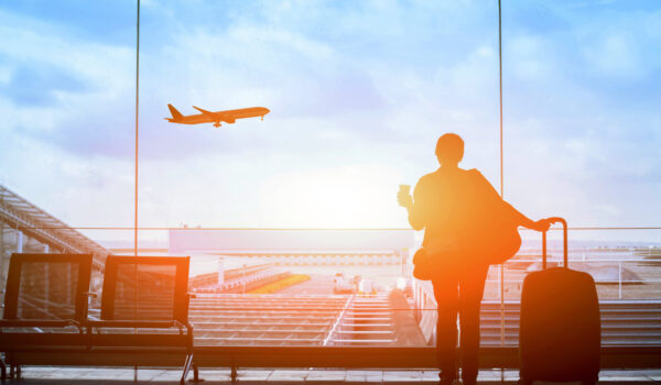 happy traveler waiting for the flight in airport, departure terminal, immigration concept