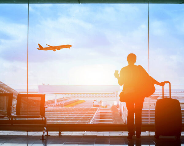 happy traveler waiting for the flight in airport, departure terminal, immigration concept